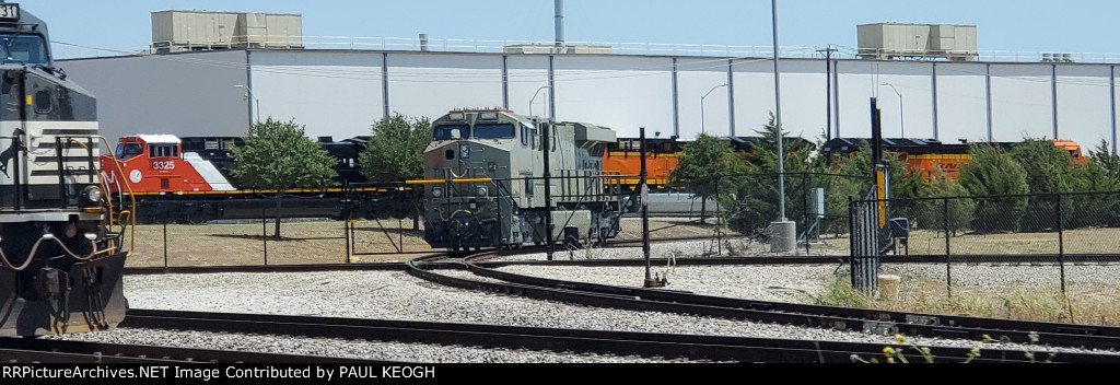 A primered BNSF 3283 (ES44ACH Tier 4 Credit) with CN 3325 (AC44C6M), BNSF 3667 and BNSF 3668 (ET44ACH's) in the Bactground..